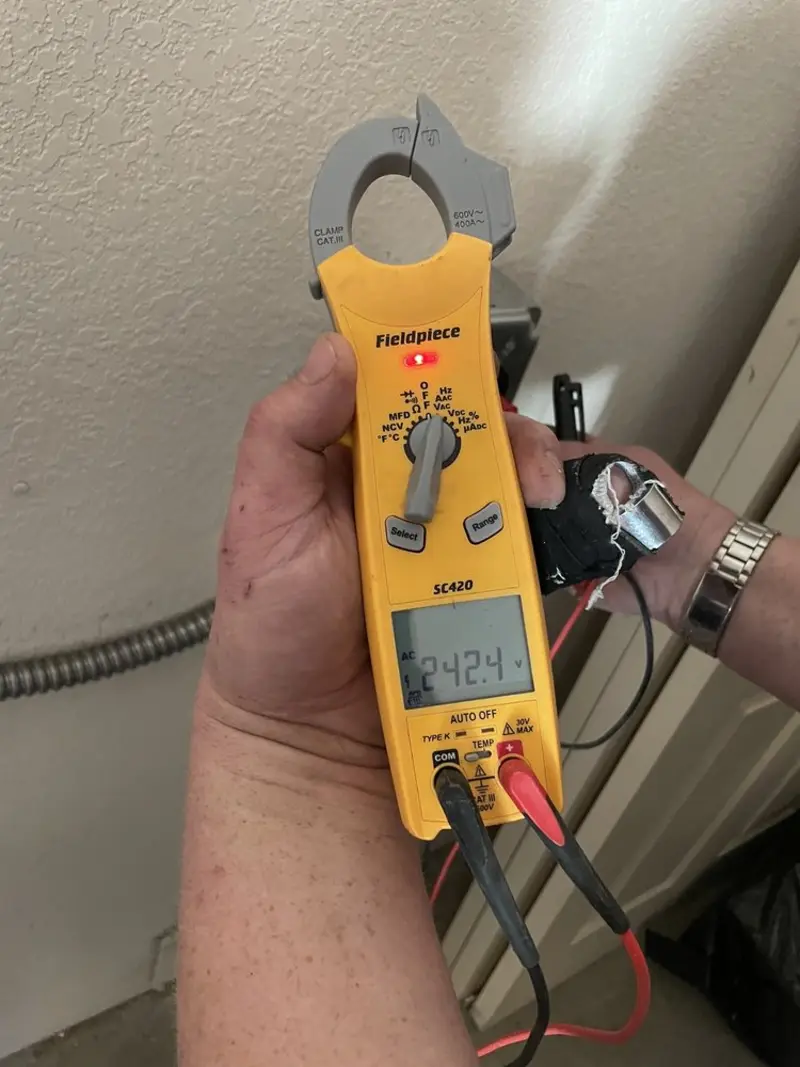Voltage testing with clamp meter during Recessed Lighting Installation in McMinnville